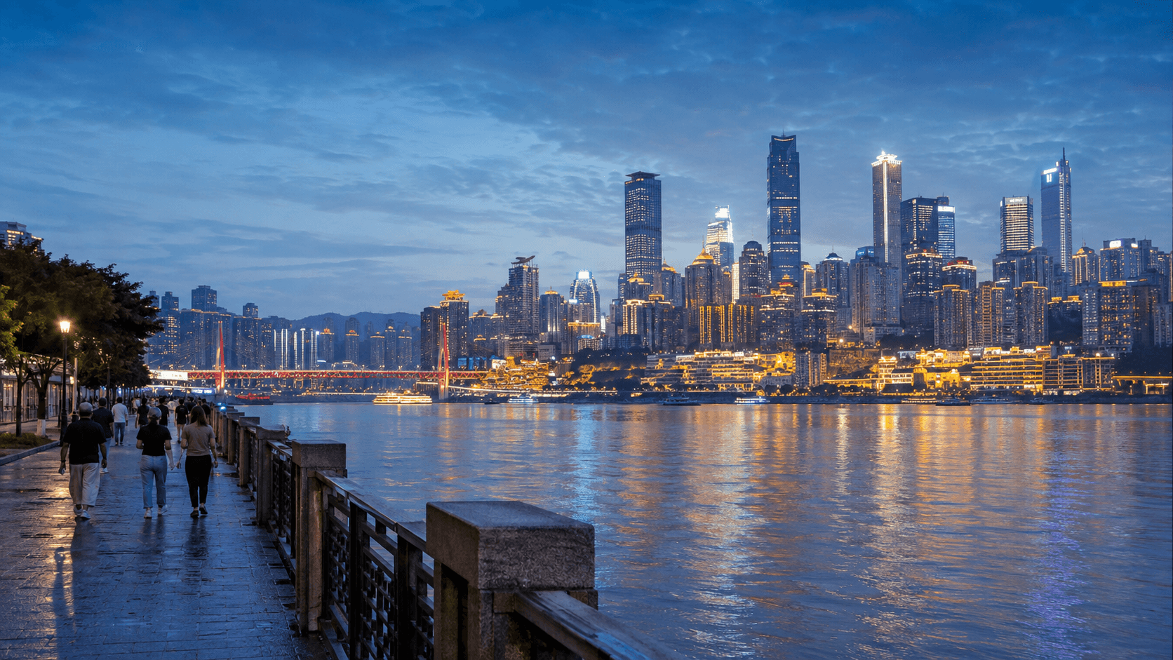 Blue-hour riverfront walk on Nanbin Road facing the illuminated Yuzhong skyline