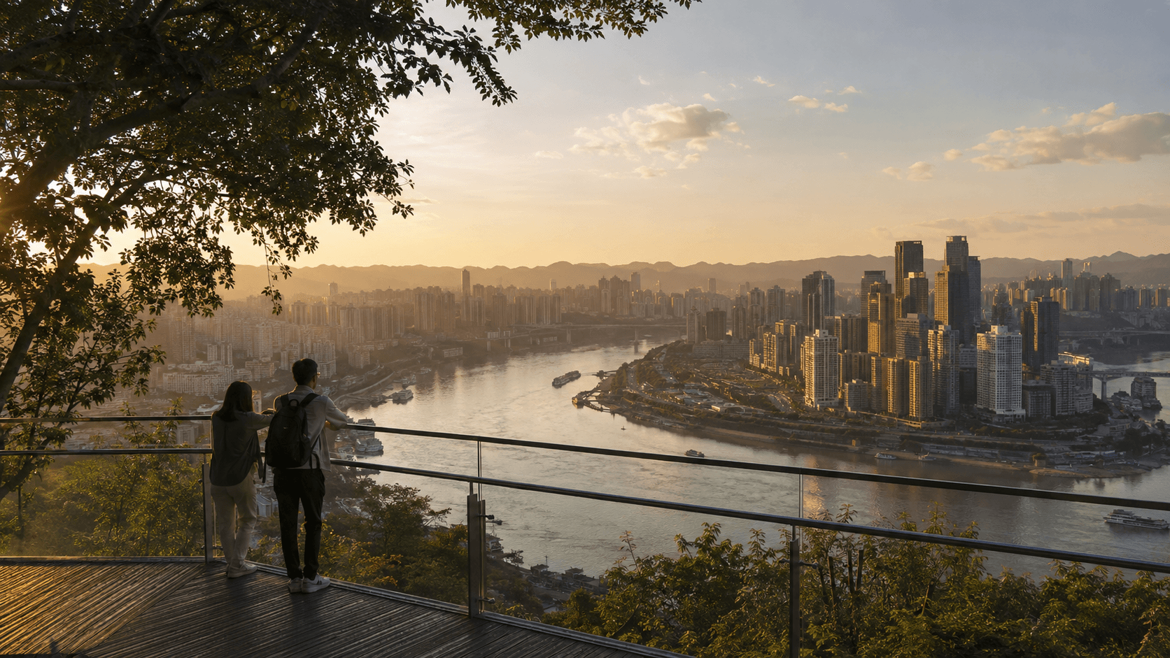 Warm sunset view from a tree-framed terrace over the Yangtze and central Chongqing