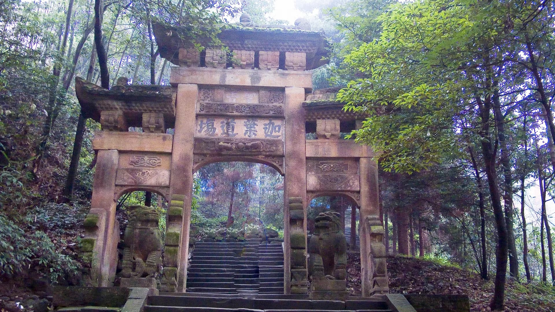 縉雲寺懸有匾額的石牌坊、兩座獅子雕塑與林間階梯